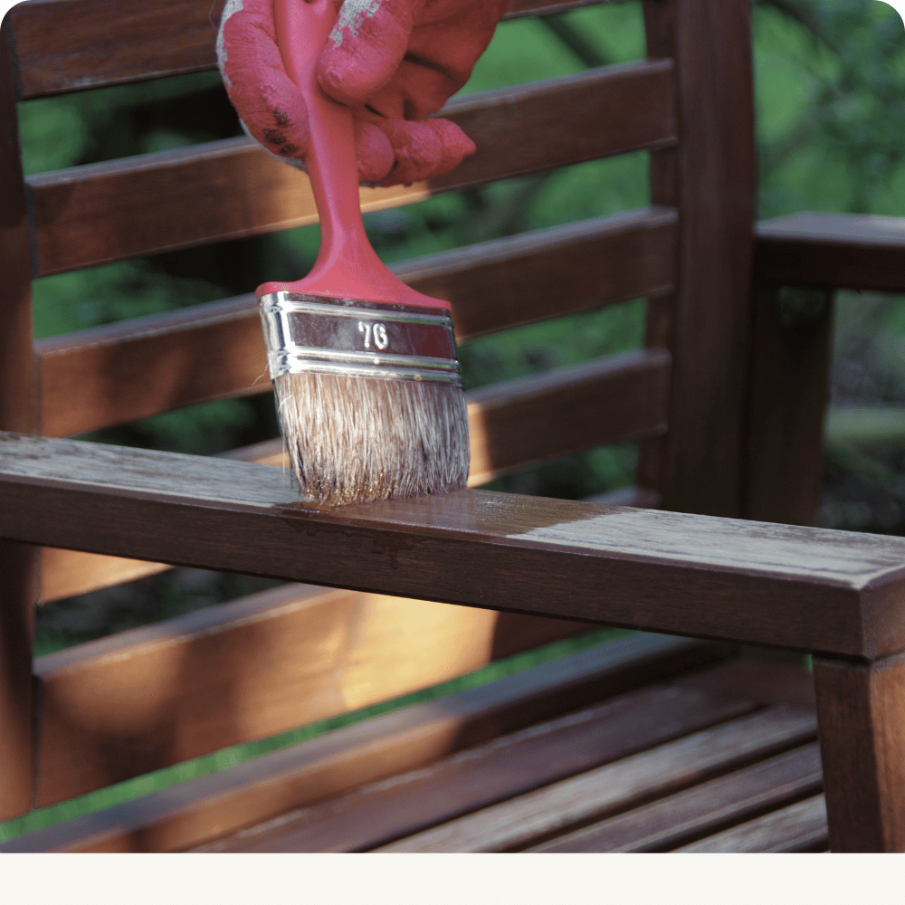 Wood furniture being painted with a brush
